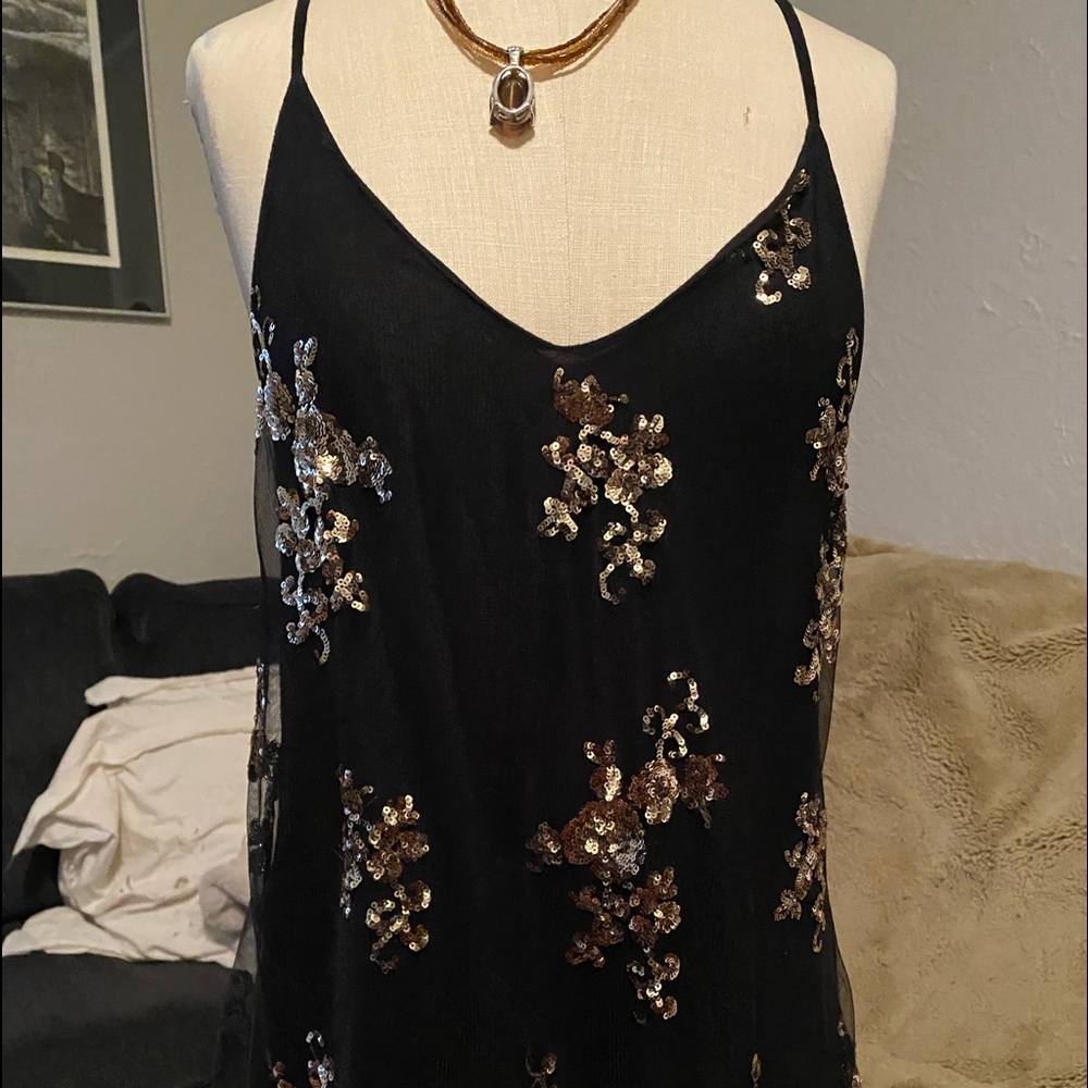 Sheer gold sequence over cotton.